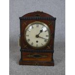 A 19th century mahogany and brass inlaid dome topped mantle clock, the white painted dial with black