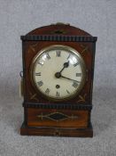 A 19th century mahogany and brass inlaid dome topped mantle clock, the white painted dial with black