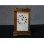 An early 20th century brass cased carriage clock, the white dial with black painted Roman