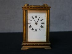 An early 20th century brass cased carriage clock, the white dial with black painted Roman