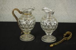 A matched pair late 19th / early 20th century brass handled dimple glass jugs raised stepped