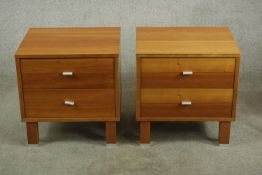 A pair of Scandinavian design Cherrywood two drawer bedside cabinets with brushed steel handles,