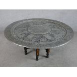 A mid 20th century heavy Sri Lankan pierced white metal, possibly pewter folding table raised on six