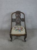 A late 19th / early 20th century Anglo Indian carved hardwood spoon back chair, the pierced splat