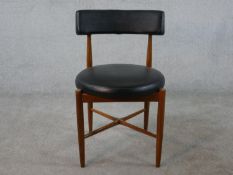 A 1960s G-Plan teak Fresco dining chair, upholstered in faux leather to the curved back and circular