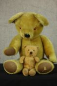 An early 20th century Merrythought brown articulated limb teddy bear together with a Chiltern