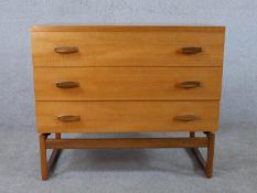 Ernst Gomme for G-Plan, a 1970s teak chest, with three long drawers, the end supports joined by a