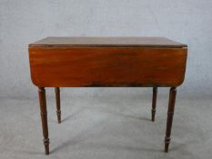 A George III mahogany drop leaf Pembroke style table raised on turned supports. H.72 W.90 D.94cm (