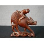 A 19th / early 20th century Chinese hardwood carved figure of man on the back of an oxen with