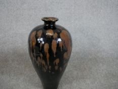 A Chinese pottery baluster shaped vase with oil spot glaze and unglazed foot. H.20 W.36 D.20cm.