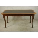 A late 19th / early 20th century, possibly French mahogany and leather inset shaped canted top