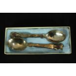 A pair of boxed Georg Jensen plannished silver spoons each engraved with shell decoration and set