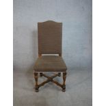 A set of four hump back dining chairs, upholstered in brown fabric to the back and seat, raised on