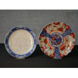 A late 19th / early 20th century Japanese Imari scalloped edged plate decorated with panels of