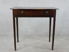 An 18th century mahogany side table, with a bow fronted top over a long drawer on square section