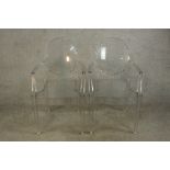 A matching pair of Philippe Stark Kartell Louis Ghost Christal open arm chairs raised on square