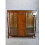 An early 20th century Georgian style twin door mahogany display cabinet; with glass astragel