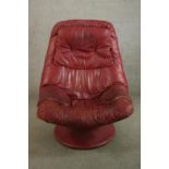 A late 20th century Scandinavian Stressles style red leather chair with footstool. H.105 W.80 D.