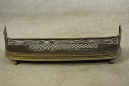 A late 19th century pierced brass fender raised on ball feet. H.28 W.110 D.27cm.