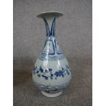 Chinese blue and white porcelain pear shaped vase, decorated with flowers and leaves, raised on