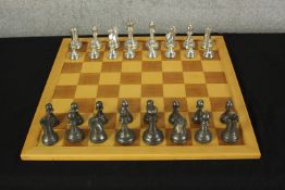 A contemporary brass chess set complete with board. H.10 W.50 D.50cm.