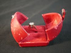 A red leather boxed 14 carat white gold diamond solitaire ring with an approximate carat weight of