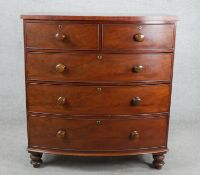 A Victorian mahogany bow front chest of two short over three long graduated cockbeaded drawers