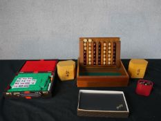 Assorted games to include a 20th century cased mahjong set, leather cased bridge set, a wooden cased