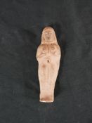 A terracotta Egyptian Shabti / Ushabhi doll; cast in the form of a lady wearing a wig, H.10.5 W.4