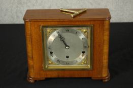 An Art Deco Elliot of London walnut cased mantle clock, the silvered dial with black etched Roman