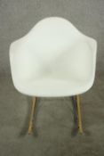 After Charles and Ray Eames a RAR rocking armchair with white plastic bucket seat, raised on