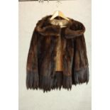A lady's vintage half-length mink fur coat with fur fringing, labeled Marshall & Snelgrove, London.