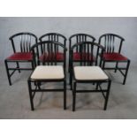 A set of six circa 1990s ebonised ash dining chairs, with curved backs, four upholstered in burgundy
