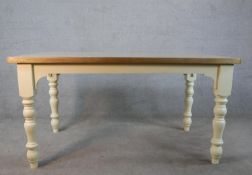 A contemporary Victorian style kitchen table, the pine rectangular top on a painted base with turned