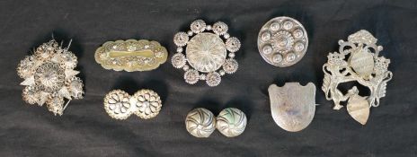 A collection of nine silver and white metal Danish traditional folk costume brooches, one with a