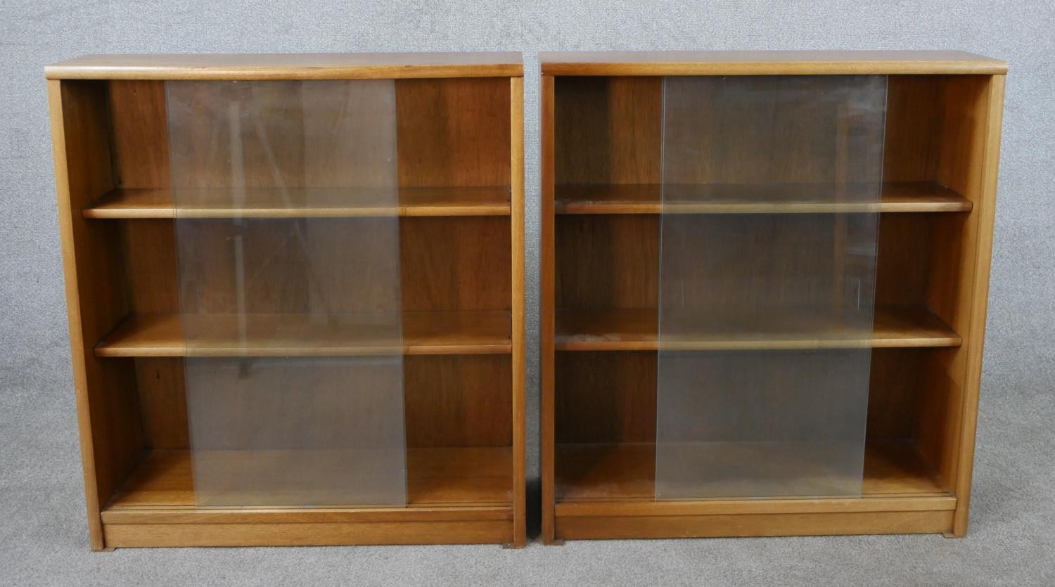 A pair of circa 1970s Jonell bookcases, with a pair of glass sliding doors enclosing shelves, on a - Image 2 of 8