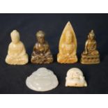 A collection of six carved Buddhas, including a bone Buddha head, jade Buddha, three carved
