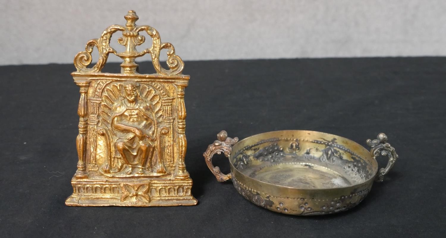 A 19th century gilt brass pocket easel shrine of a seated gentlemen together with a gilt brass