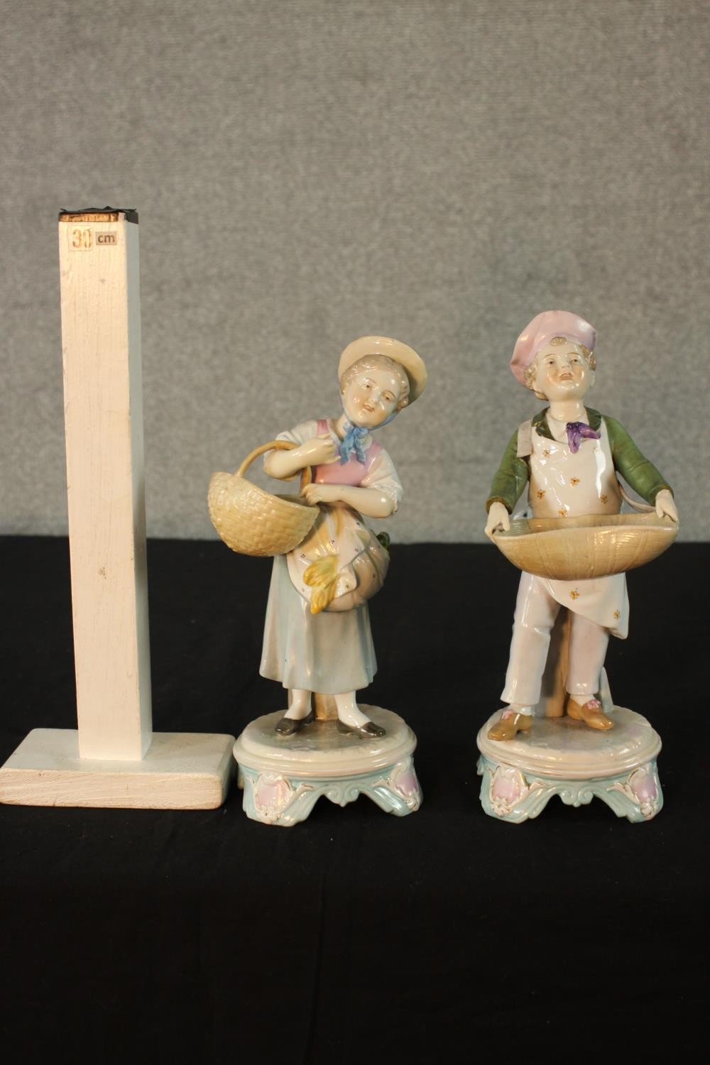 A pair of late 19th / early 20th century Continental porcelain figures of a man and a woman carrying - Image 2 of 12