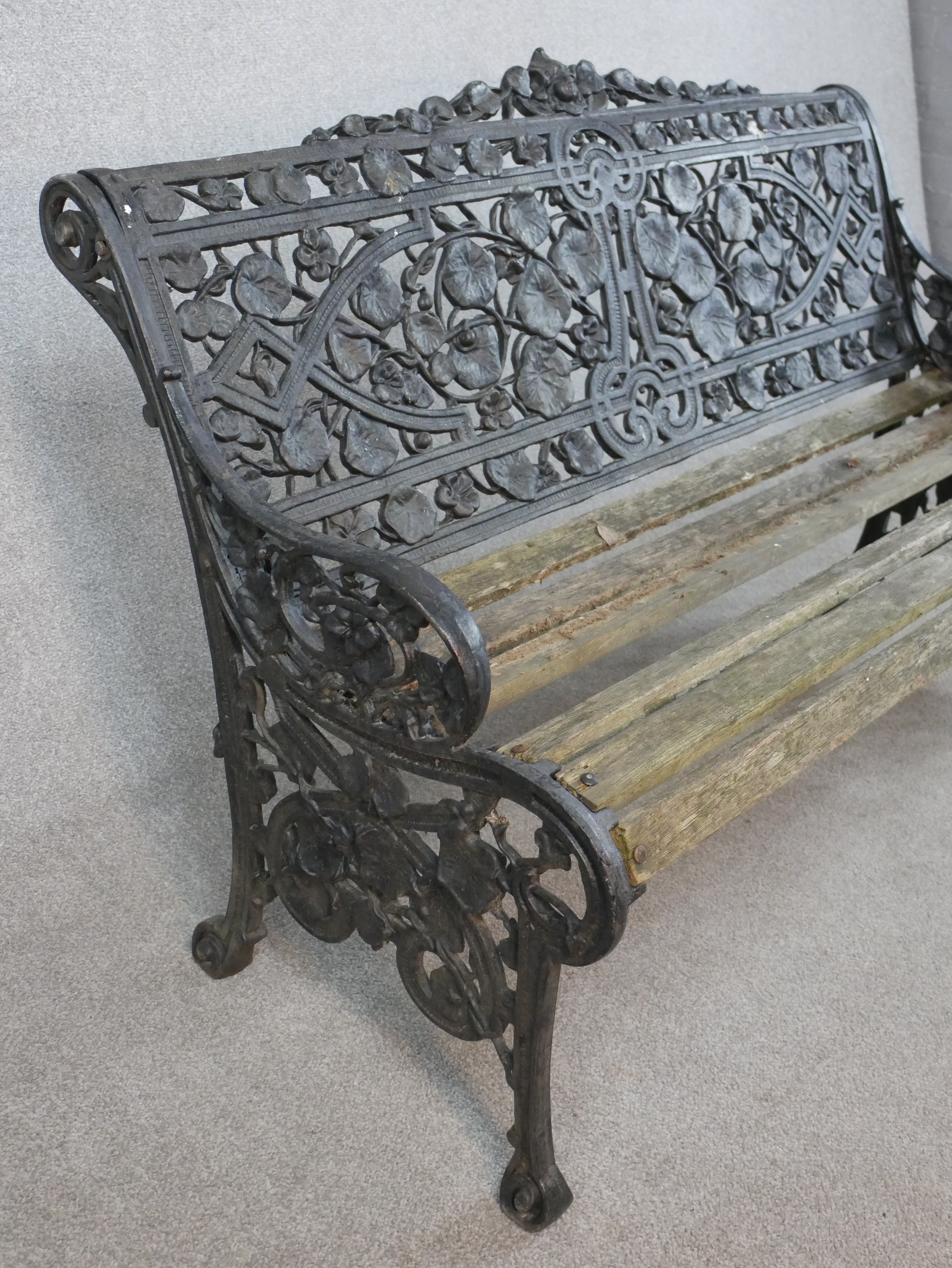 A Victorian Coalbrookdale style cast iron garden bench, in nasturtium pattern, missing one seat - Image 8 of 9