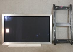 A Bang & Olufsen Beovision 4 - 50 colour television with wall bracket.