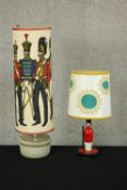 A carved and painted wooden lampbase in the form of a solider together with a mid 20th century