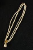 A leather boxed Majorica knotted artificial pearl two strand necklace necklace with pear pendant