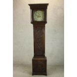 A late 18th / early 19th century carved oak longcase clock, the white painted enamel dial with black