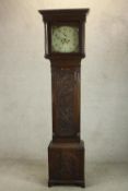 A late 18th / early 19th century carved oak longcase clock, the white painted enamel dial with black