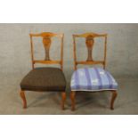 A matched pair of Edwardian walnut framed carved and pierced splat back nursing chairs with stuff