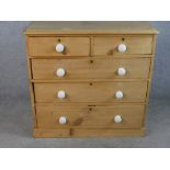 A late 19th / early 20th century chest of two short over three long drawers with white porcelain