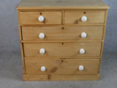 A late 19th / early 20th century chest of two short over three long drawers with white porcelain