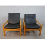 A pair of mid 20th century Cornwall - Norton teak open armchairs, model 10 / 11, with black