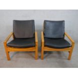 A pair of mid 20th century Cornwall - Norton teak open armchairs, model 10 / 11, with black